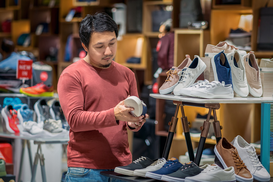 Man shopping for shoes in retail store